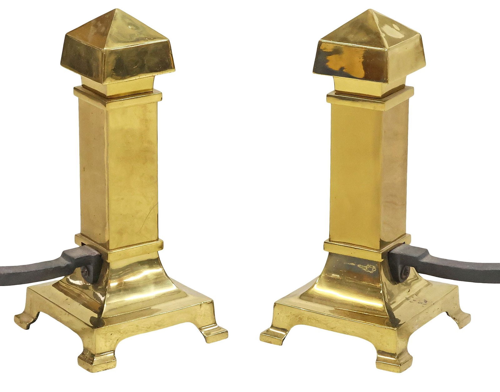 (2) BRASS COLUMN-FORM FIREPLACE ANDIRONS: (pair) Brass fireplace andirons, 20th c., each having pointed finial, over columnar-form body, rising on square-legged plinth, on an iron billet bar, approx 18"h, 8.25"w, 26"d, 34lbs total **Provenanc