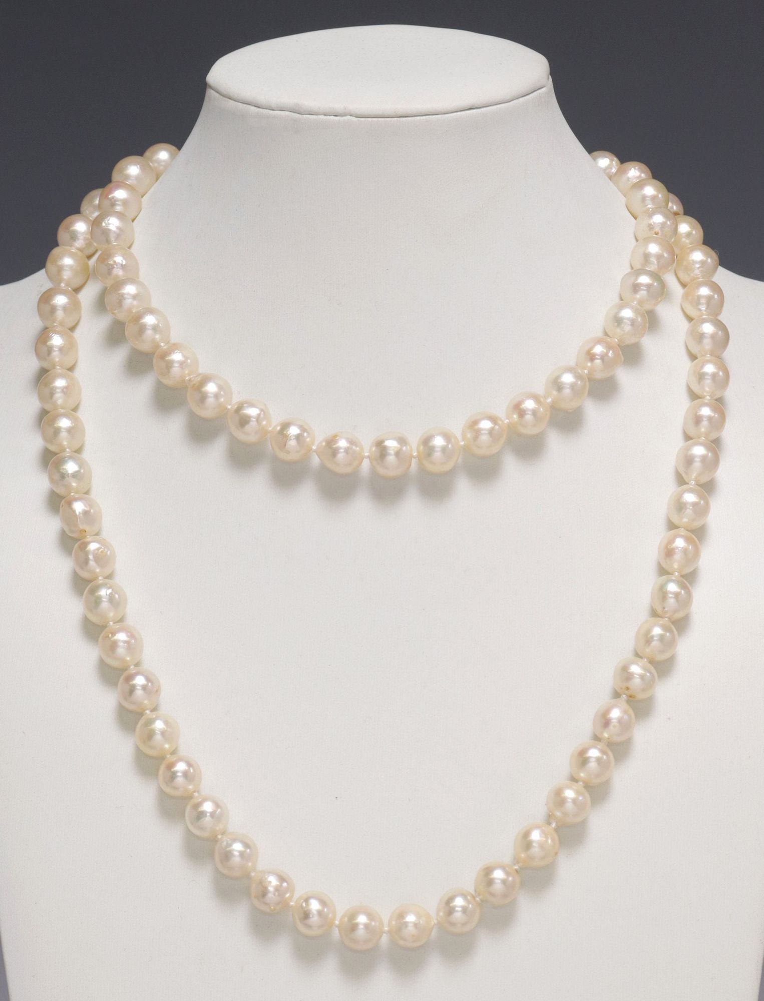 ESTATE OPERA LENGTH CULTURED FRESHWATER BAROQUE PEARL & 14KT DIAMOND NECKLACE: Estate opera-length pearl necklace, the strand comprised of (eighty-six) cultured freshwater pearls, approx 9mm-10mm, 18kt yellow gold ringed barrel-form push clasp with two rows of (ten) round brilli