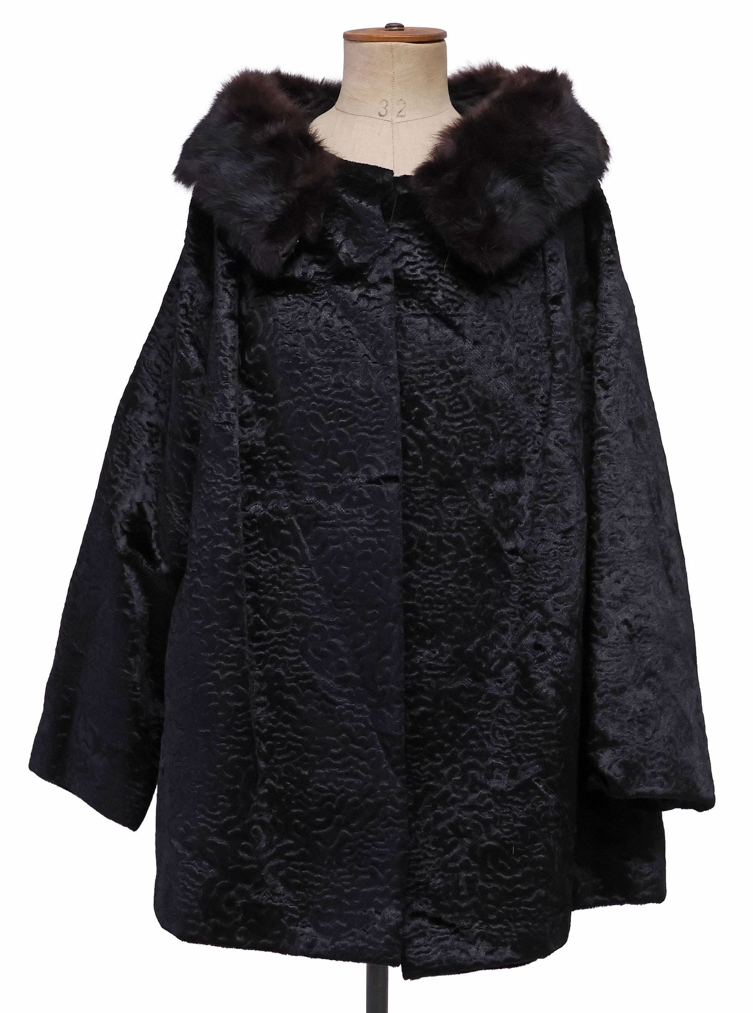 LADIES BROADTAIL LAMB & MINK FUR COLLAR MESS COAT: Ladies broadtail lamb fur coat, having brown mink fur collar with hook-and-eye clasps, front button closure, three-quarter length sleeves, black fabric interior lining, shoulder: approx 19"w, sleeve: