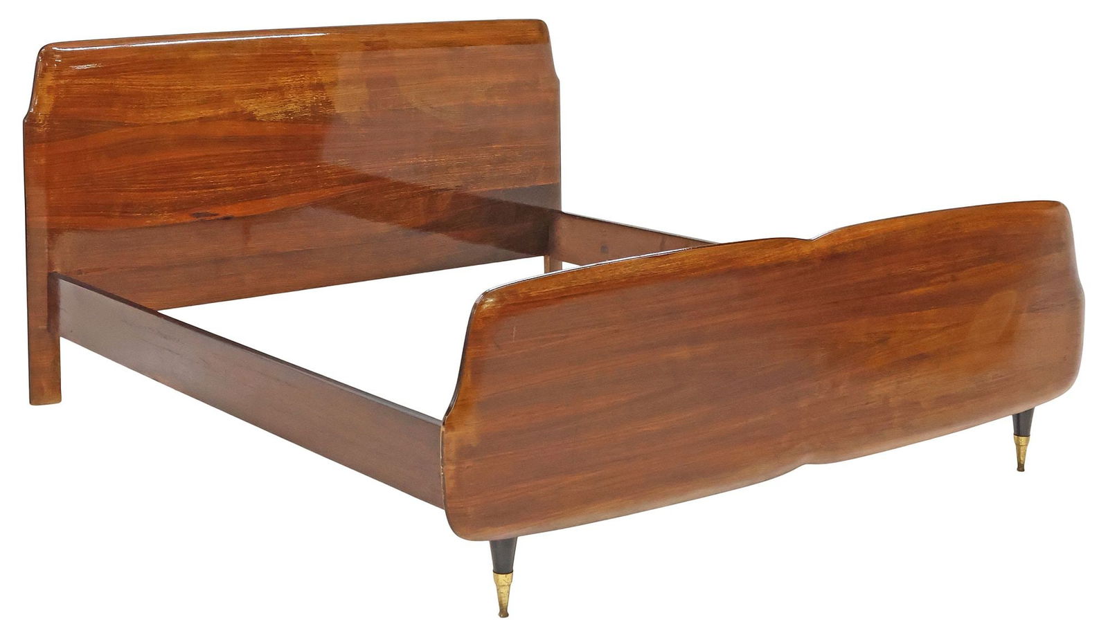 ITALIAN MID-CENTURY MODERN PARCEL-EBONIZED WALNUT BED: Italian mid-century modern lacquered walnut bed, c.1950s, having curvilinear headboard and footboard with parcel-ebonized trim, rising on tapered front legs, ending on brass cap feet, exterior: approx
