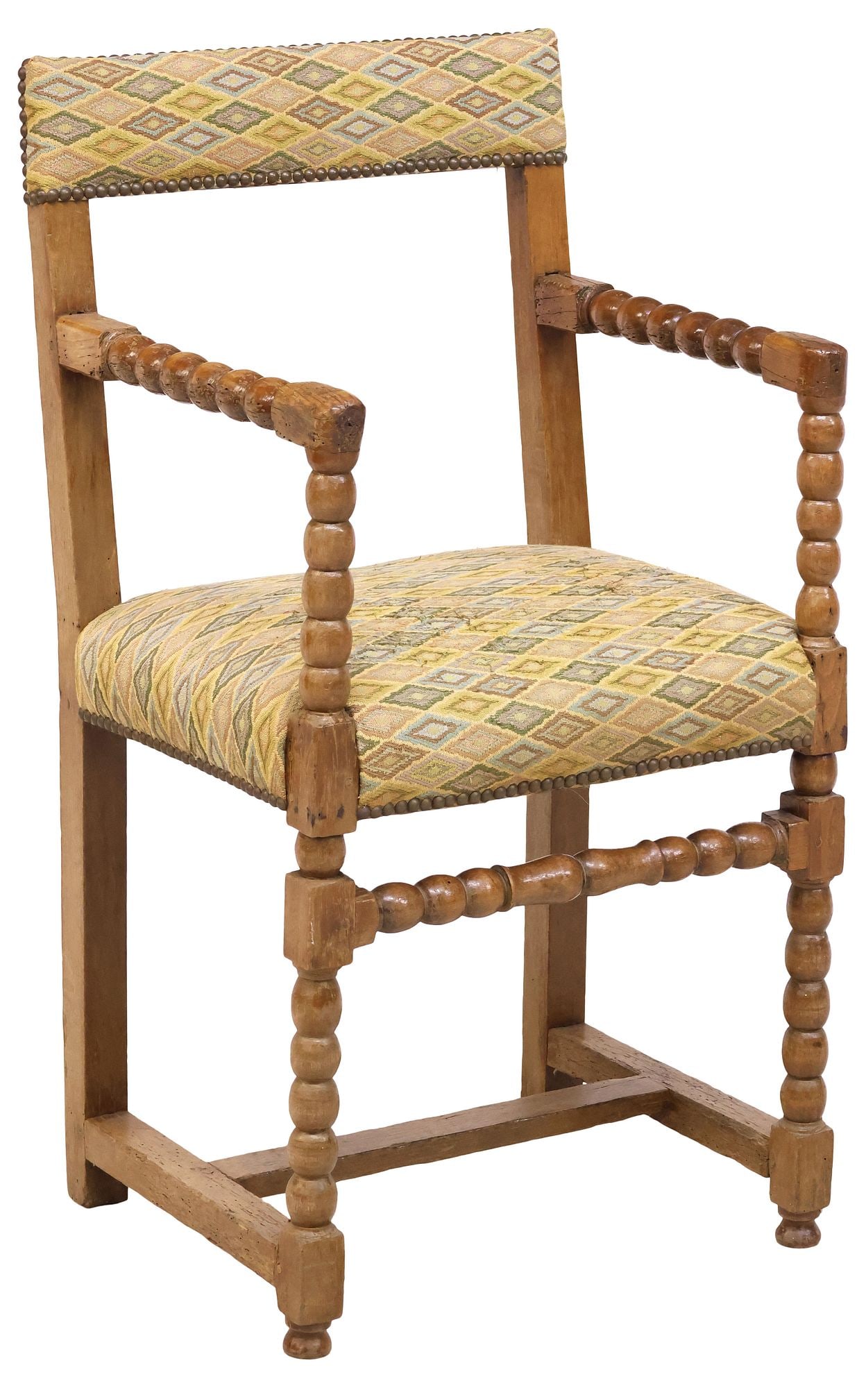 ENGLISH GEORGIAN UPHOLSTERED BOBBIN-TURNED OAK ARMCHAIR: English George III period carved oak armchair, early 19th c., having padded top rail and seat in later patterned fabric upholstery, with nailhead trim, bobbin-turned arms and legs, joined by H stretch