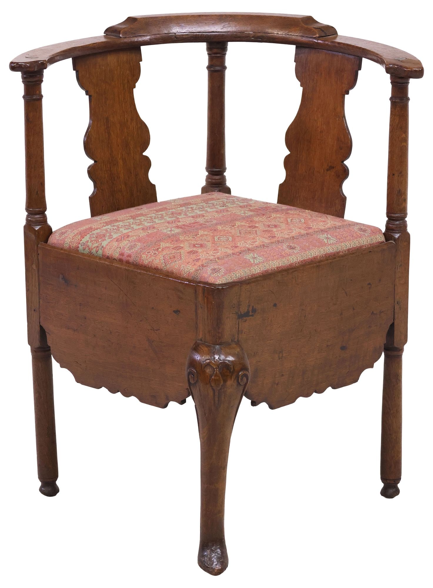 ENGLISH GEORGIAN PERIOD UPHOLSTERED OAK CORNER CHAIR: English Georgian period oak corner chair, late 18th c., originally a commode chair, now fashioned with a slip seat in later patterned fabric upholstery, having curved top rail and vasiform splats, ove