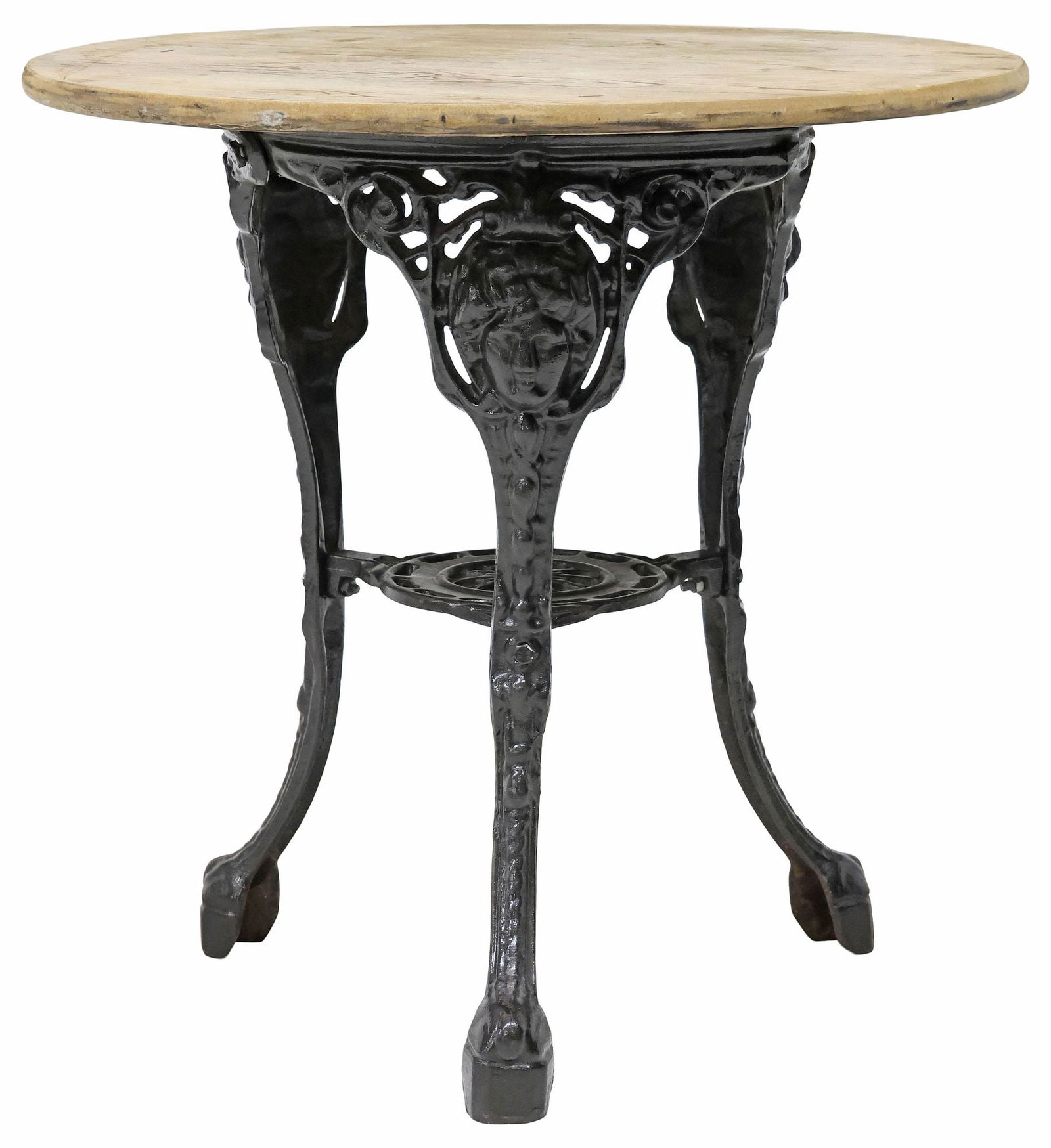 ENGLISH OAK & CAST IRON PUB TABLE: English pub table, 20th c., having circular stripped oak top, raised on cast iron tripodal base headed by Classical-style masks, joined by medial shelf, approx 27"h, 27.5"diam