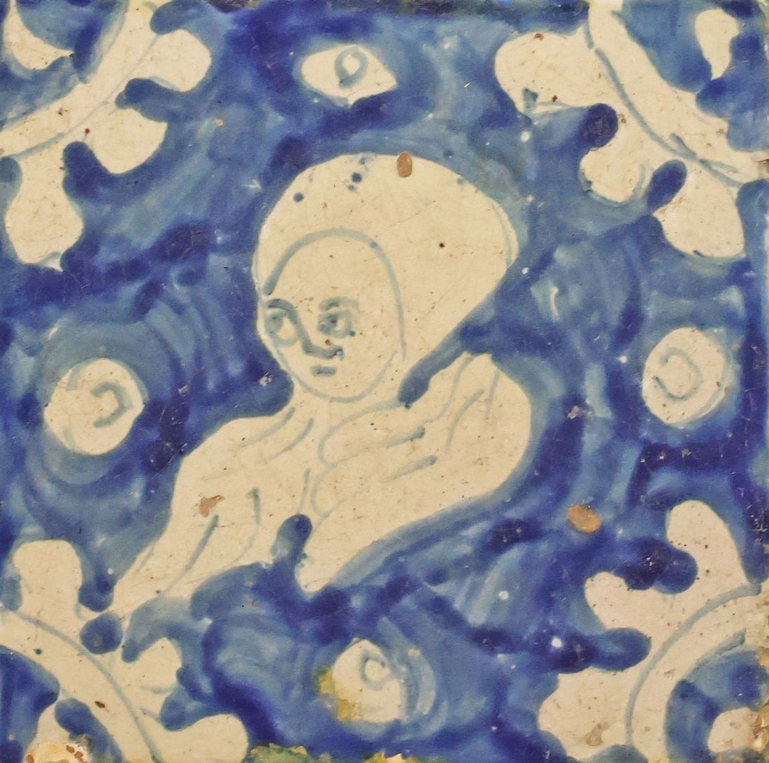 FRAMED DELFT FIGURAL TIN-GLAZED EARTHENWARE TILE: Dutch Delft blue and white tin-glazed earthenware tile, depicting the bust of a Renaissance style woman, abstract "ox-head" decoration at the corners, housed in a pine frame, tile: approx 5"h, 5"w, ov