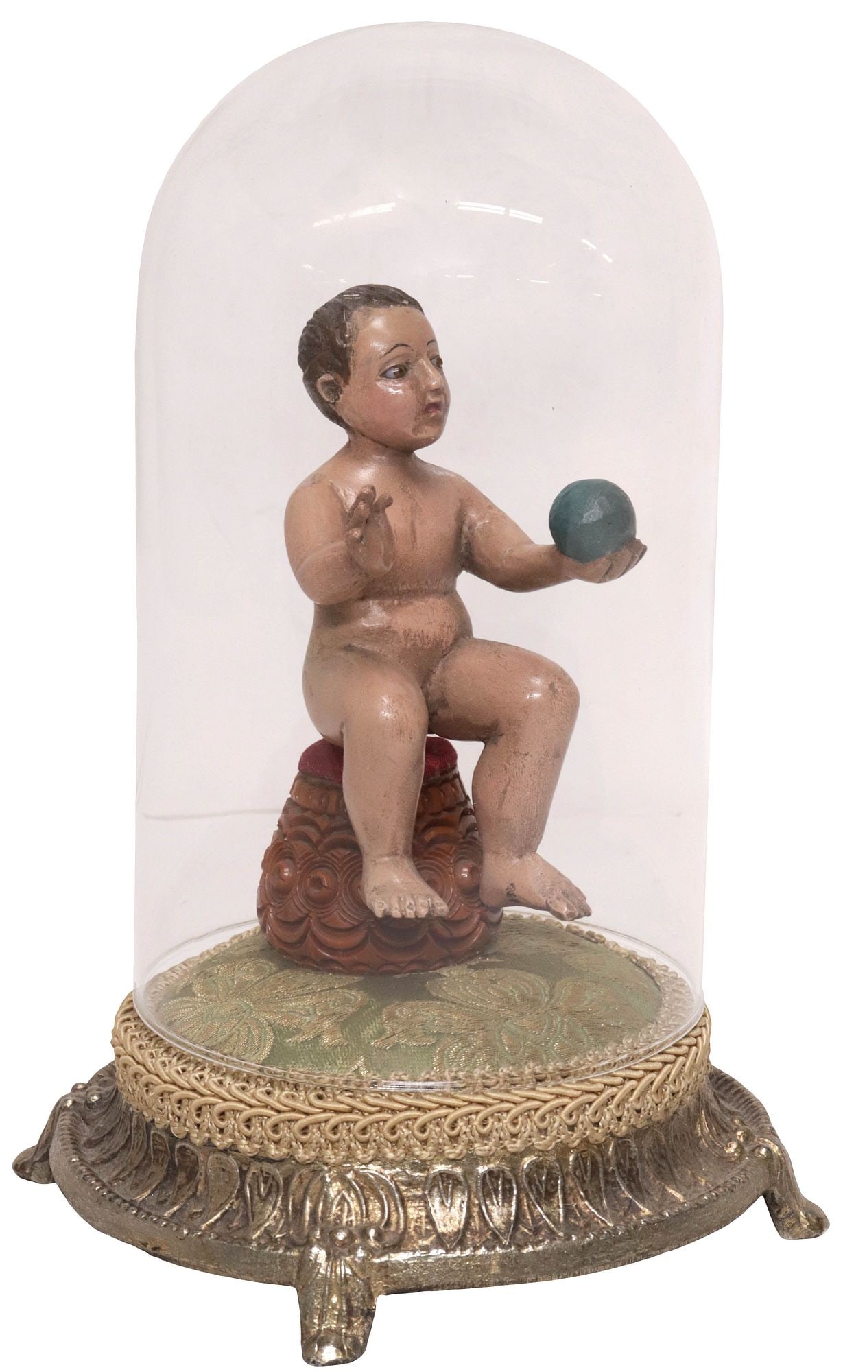 SPANISH COLONIAL SANTO FIGURE IN CLOCHE, CHRIST CHILD WITH GLOBUS CRUCIGER: Spanish Colonial carved and polychrome-painted santo figure, Infant Christ with Globus Cruciger, with inset glass eyes, one hand holding blue orb and the other raised, seated on a pedestal, further