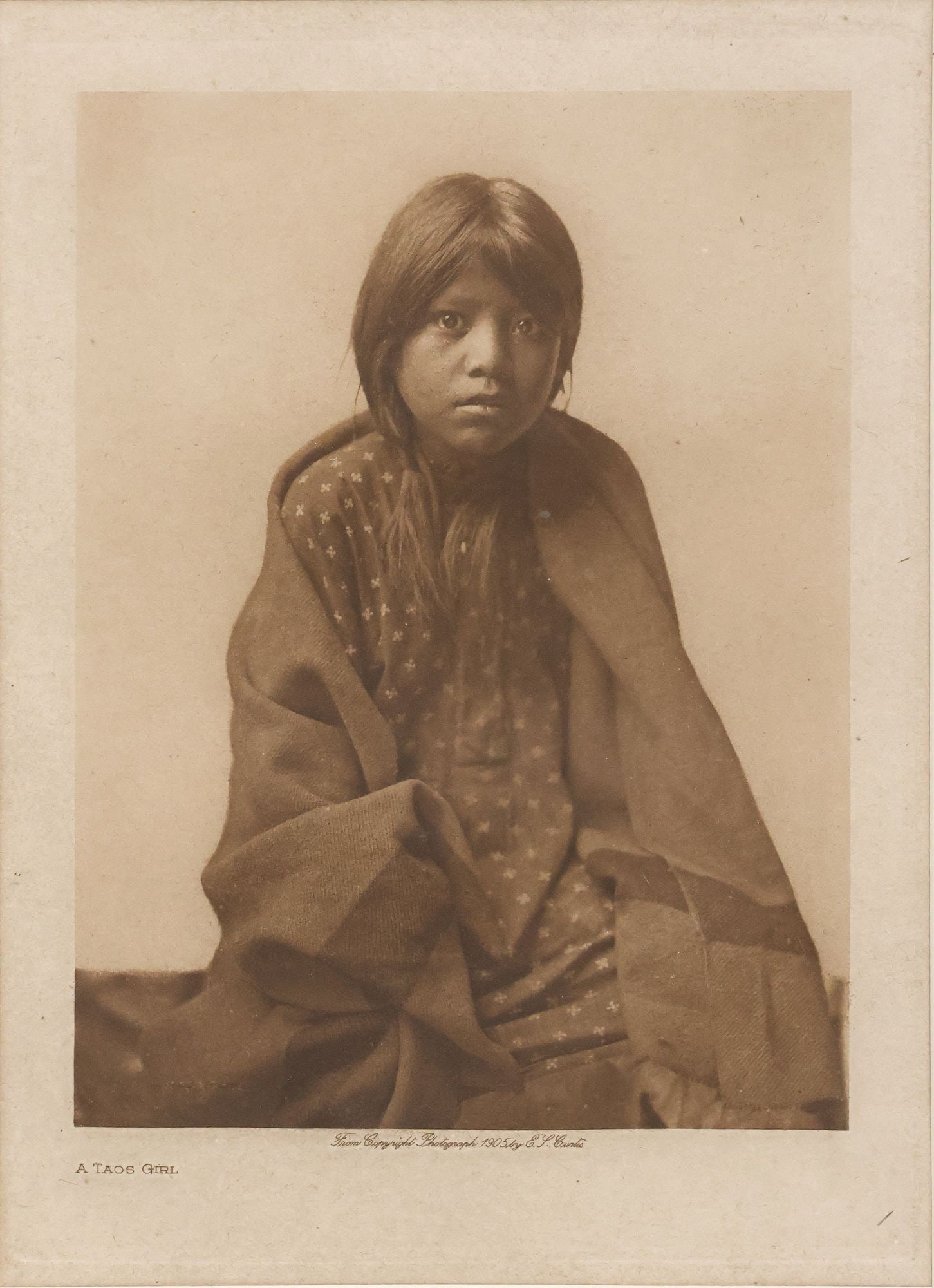 AFTER EDWARD S. CURTIS (D.1952) PHOTOGRAVURE PRINT, 'A TAOS GIRL' (1 of 7)