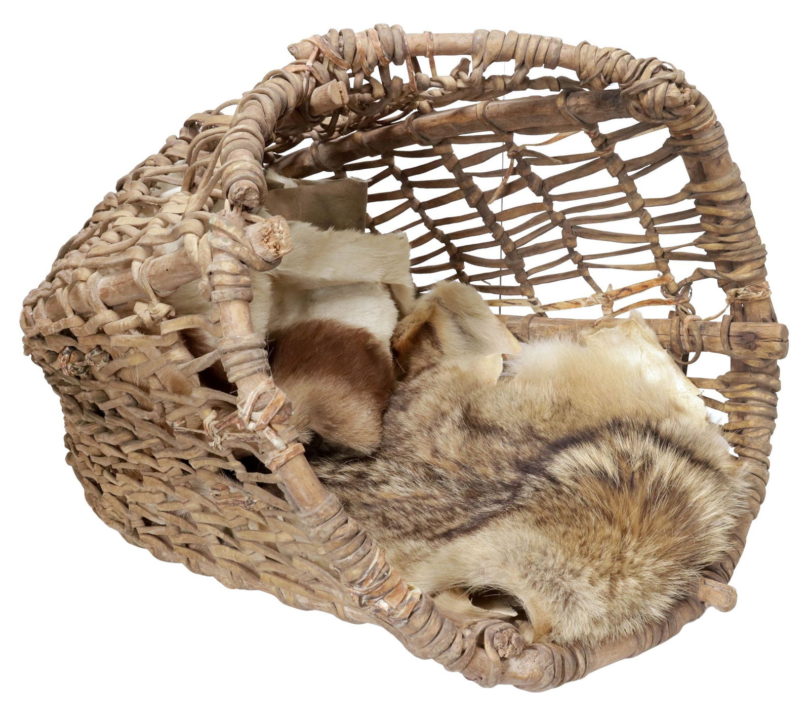 LARGE WOVEN RAWHIDE BURDEN BASKET & FUR HIDES: Woven burden basket, having wood frame, with woven rawhide ties, spade-shaped tool attached by wire, accompanied by additional animal hide fragments, approx 29"h, 22"w, 20"d, 12.25lbs total