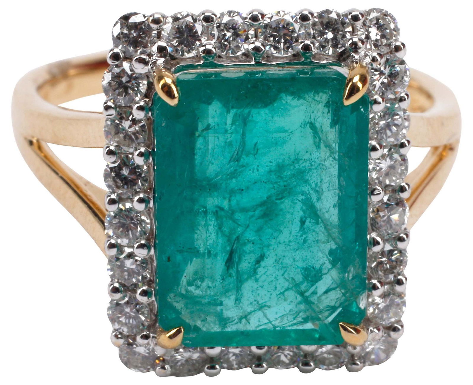 ESTATE 18KT TWO-TONE GOLD, 4.32 CT EMERALD & DIAMOND RING: Estate 18kt two-tone gold and gemstone ring, a central emerald cut emerald, approx 4.32cts, standard treatments assumed, in a white gold halo surround of (twenty-four) diamonds, approx 0.50cttw, avera