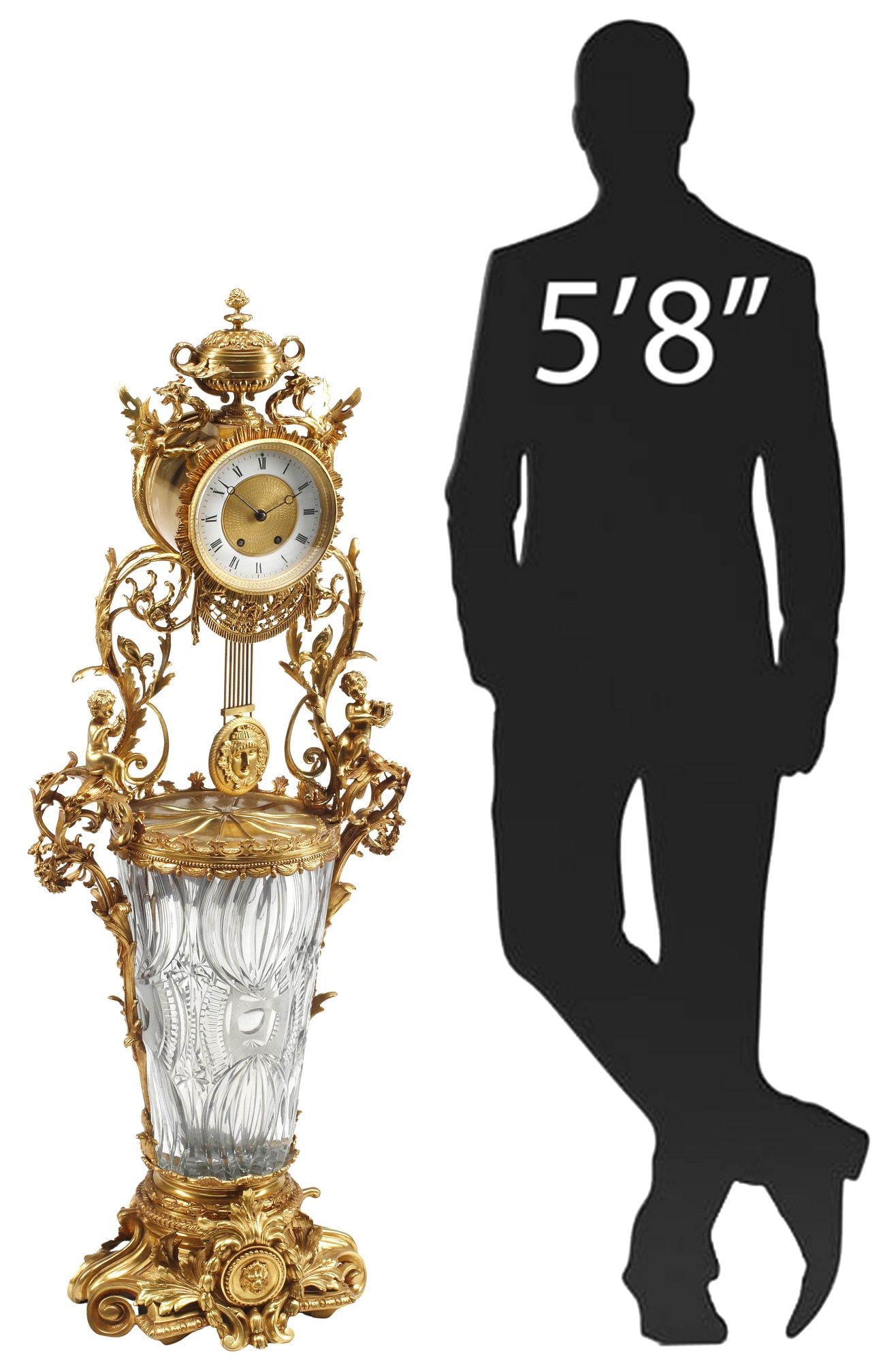 LARGE NEOCLASSICAL STYLE ORMOLU & CUT CRYSTAL VASE CLOCK, 44.5"H: Large Neoclassical style cut crystal and bronze dore clock, having urn-form finial, over winged grotesques and sunburst frame, encasing dial with Roman numeral hour markers, time-and-strike movement m
