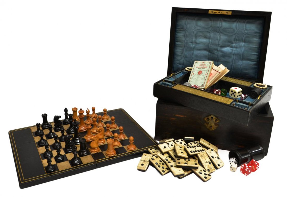 VICTORIAN COROMANDEL FITTED GAMES COMPENDIUM BOX: Victorian coromandel traveling games compendium, 19th c., a curved lid above the locking, fitted box with ornate brass escutcheon, removable, sectioned tray featuring 'Bezique' score keeper and pegs, 