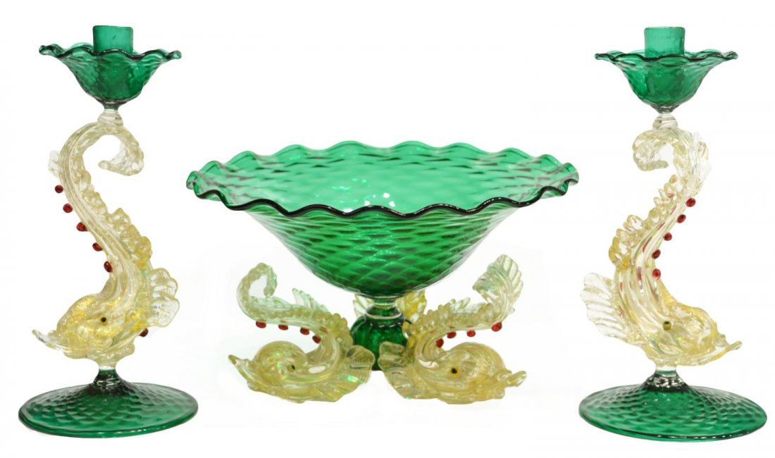 (3) VENETIAN ART GLASS DOLPHIN CONSOLE SET: (set of 3) Venetian art glass garniture set, comprising: (pair) candlesticks having figural stems modeled as dolphins with gilt flecks, green candle cups and base in a diamond pattern, 11.75"h; (1) gr