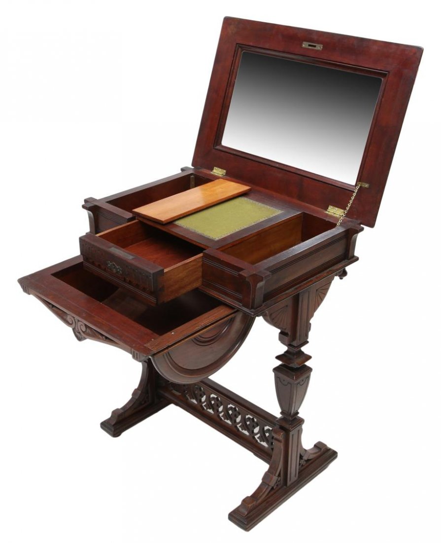 FINELY CARVED VICTORIAN WALNUT WORK / SEWING TABLE: Victorian walnut work or sewing table, 19th c., excellent pierced and carved detail throughout, the rectangular top concealing a mirror, above several compartments and a fabric lined surface enclosed 