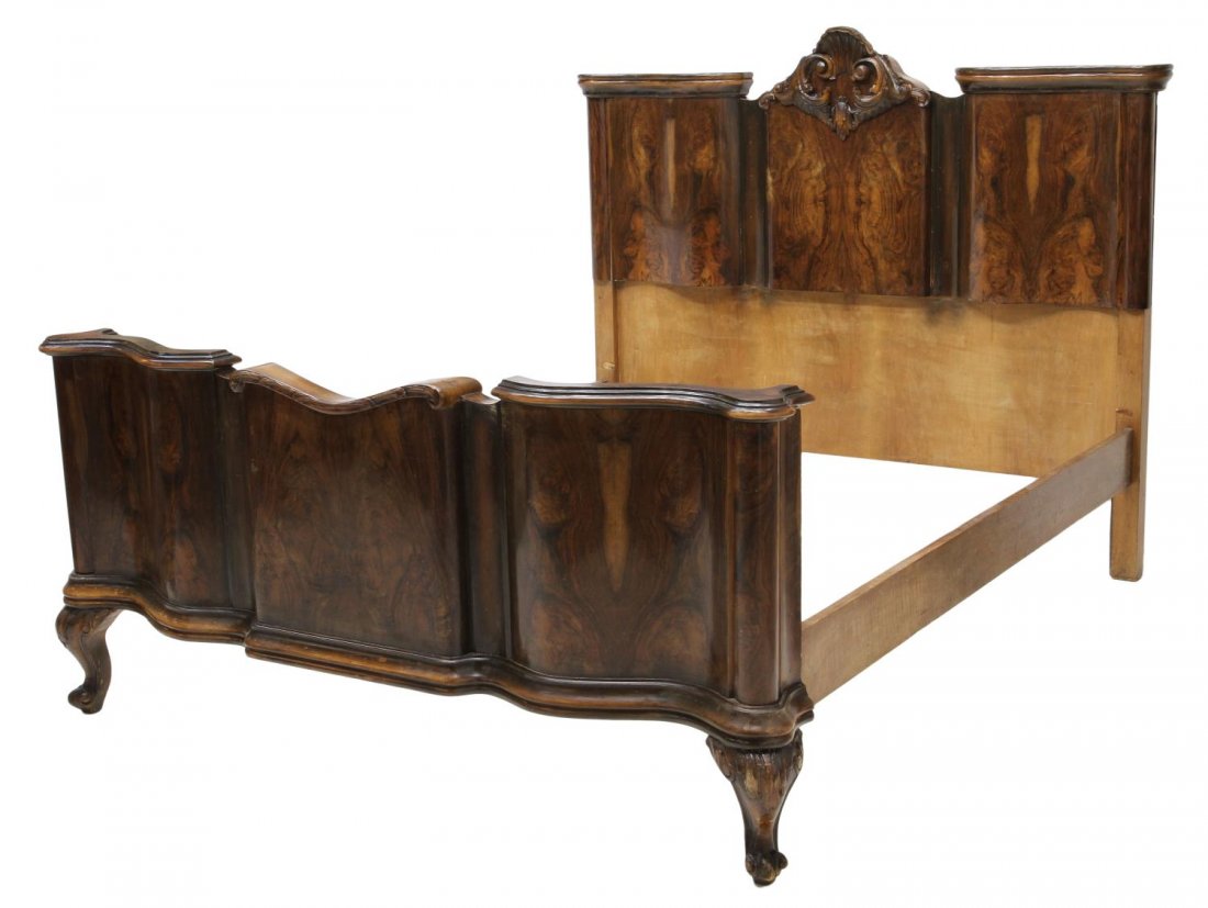 VENETIAN BAROQUE STYLE FIGURED WALNUT BED: Venetian Baroque style figured walnut veneer bed, early 20th c., centered scrolled shell final at headboard, scrolled conforming footboard rising on cabriole legs, terminating in scrolled feet, restor