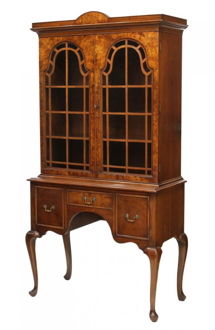 QUEEN ANNE STYLE BURLED WALNUT DISPLAY CABINET: Queen Anne style walnut cabinet on stand, doors and drawer with burled facing, shelved display behind glazed doors with faux mullions, the base having single drawer and two cabinet doors, raised on ty