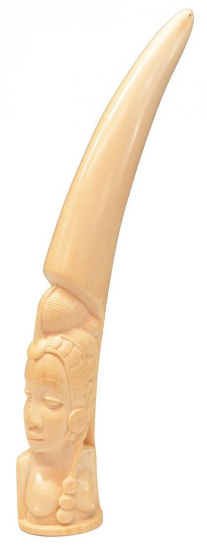 LARGE AFRICAN IVORY TRIBAL PORTRAIT TUSK CARVING: *This lot will not be shipped Internationally* African carved ivory portrait tusk, the bust of a female tribal figure with elaborately coiffed hair, 17.75"h, 2.5"w, 3"d, 3lbs Start Price: $250.00