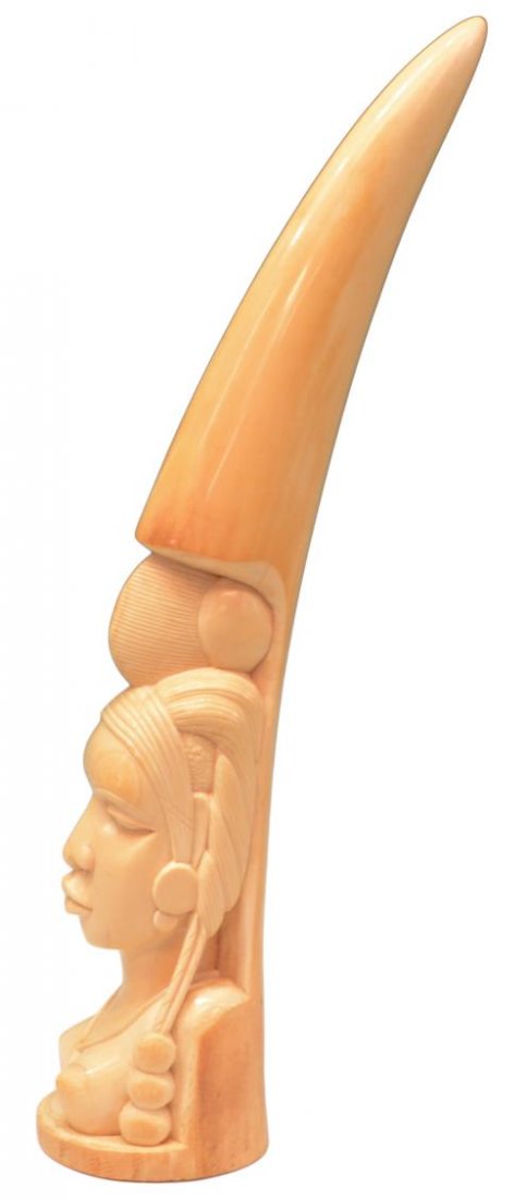 LARGE AFRICAN IVORY FIGURAL TRIBAL TUSK CARVING: *This lot will not be shipped Internationally* Substantial African solid ivory portrait tusk carving, the bust of a female tribal figure with natural curved tusk surmounting her head, 21.25" h,3.75"w,