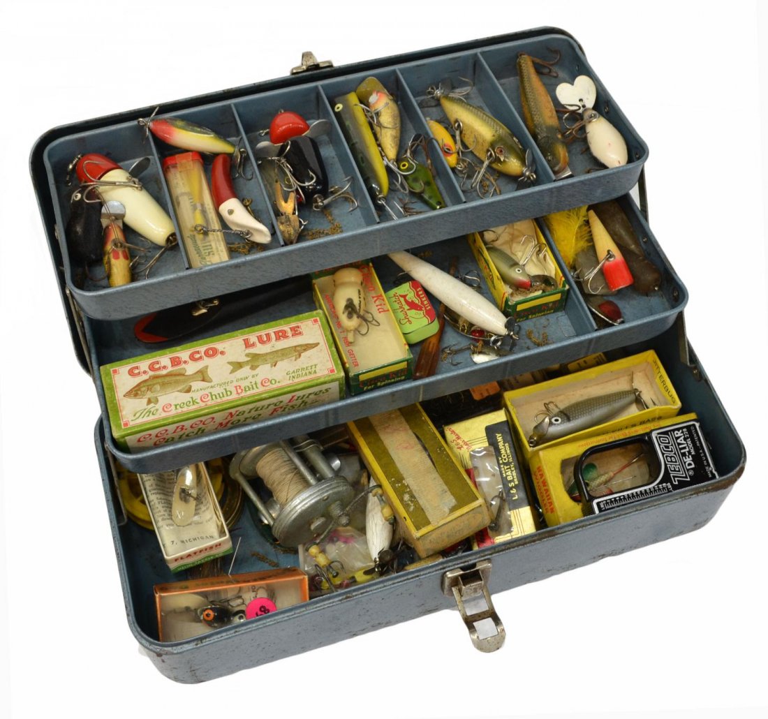 FISHING BOX PACKED FULL OF LURES & REELS: (lot) Fishing tackle box with substantial quantity of vintage lures and reels, highlights including a Shakespeare 'True Blue' 1956 reel, Creek Chub Bait Co., Cisco Kid, Flatfish, and Bomber Bait Co. l