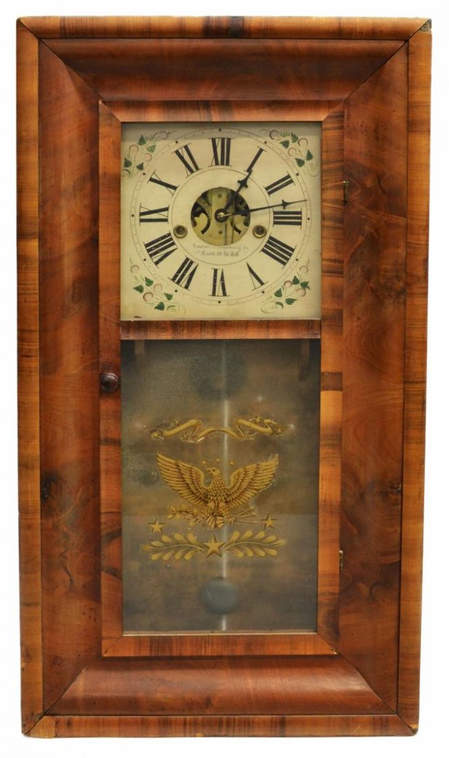 19TH C. AMERICAN OGEE WALL CLOCK, GILDED EAGLE: American circassian walnut ogee wall clock, mid 19th c., Forestville Manufacturing Company, Connecticut, the face having Roman Numeral, frosted lower window, with applied gilt eagle, some loss to fini