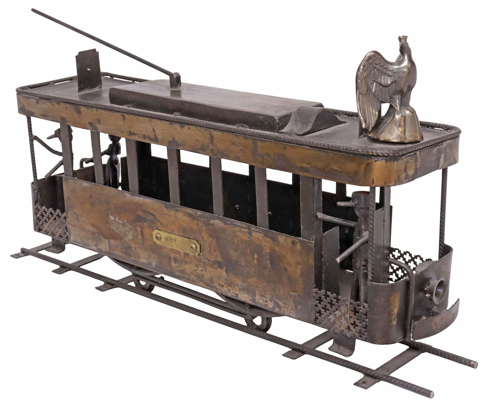 LARGE FRENCH INDUSTRIAL STYLE METAL TRAIN / STREETCAR SCULPTURE: Large Industrial style assembled metal train/ streetcar model, fashioned from reclaimed materials, topped by a crowned eagle and the coat of arms of Nice, three stylized railway workers at both ends,