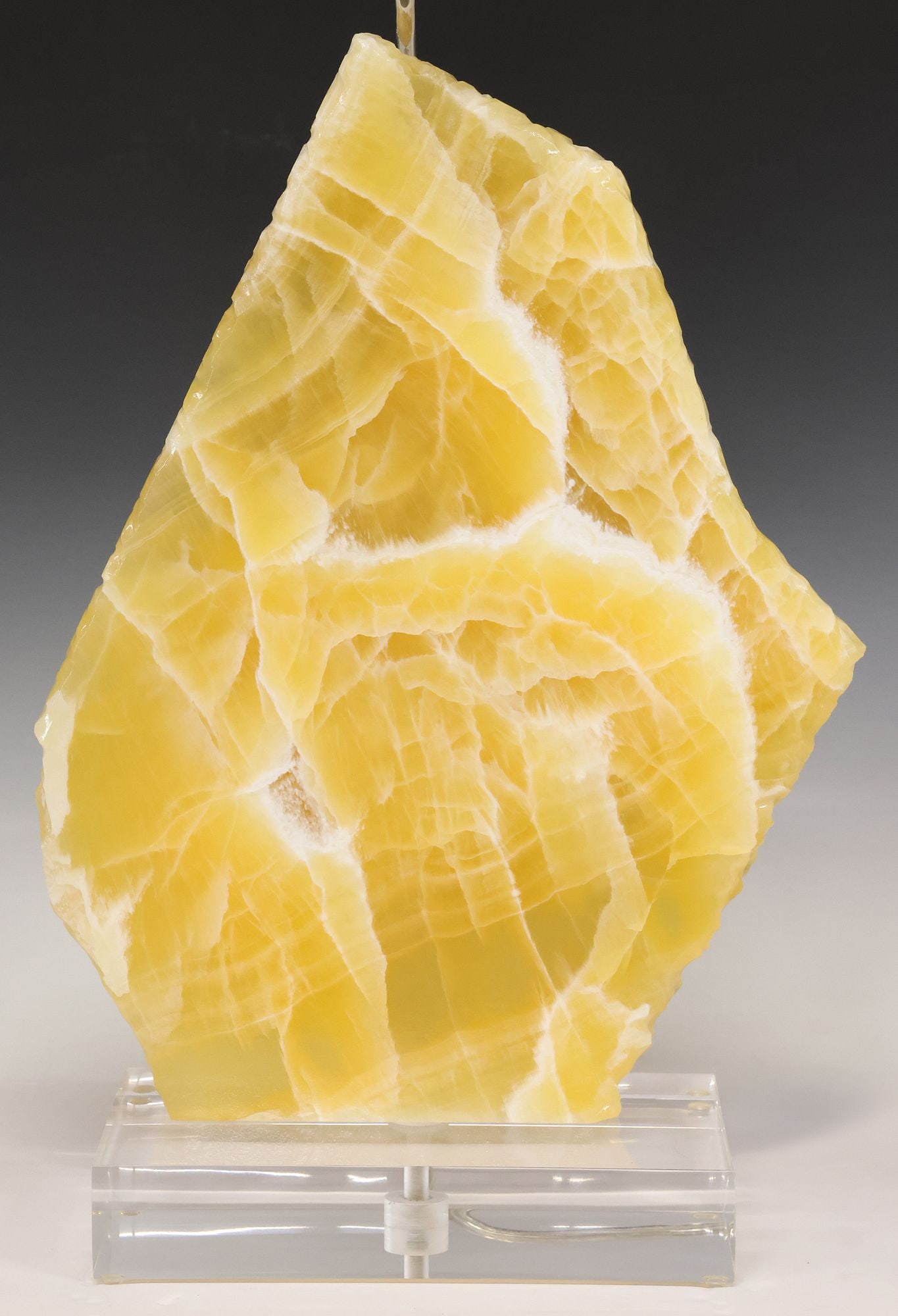 GEOLOGICAL HONEYCOMB CALCITE SPECIMEN 1-LIGHT TABLE LAMP: Geological honeycomb calcite specimen, now fashioned as a single-light table lamp, with dimmer dial, on colorless acrylic base, accompanied by fabric shade, observed operating, specimen: approx 19"h,