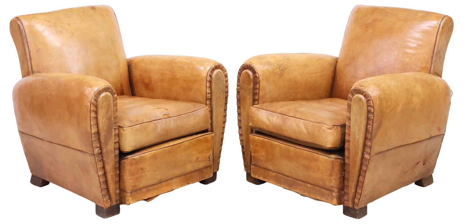 (2) FRENCH ART DECO PERIOD TAN LEATHER CLUB CHAIRS: (pair) French Art Deco period club chairs, c. 1930s, in worn tan leather upholstery, having rolled back and arms, loose seat cushion, rising on wood block feet, loss and wear to leather, approx 30"h,