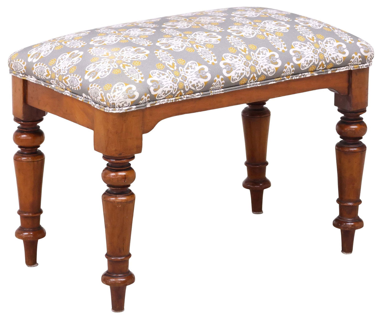 ENGLISH VICTORIAN MAHOGANY UPHOLSTERED BENCH / STOOL: English Victorian mahogany bench/ stool, late 19th c., having upholstered foliate cushion, rising on turned legs, ending on arrow feet, approx 20"h, 27"w, 16.5"d **Provenance: the Stanley Family's