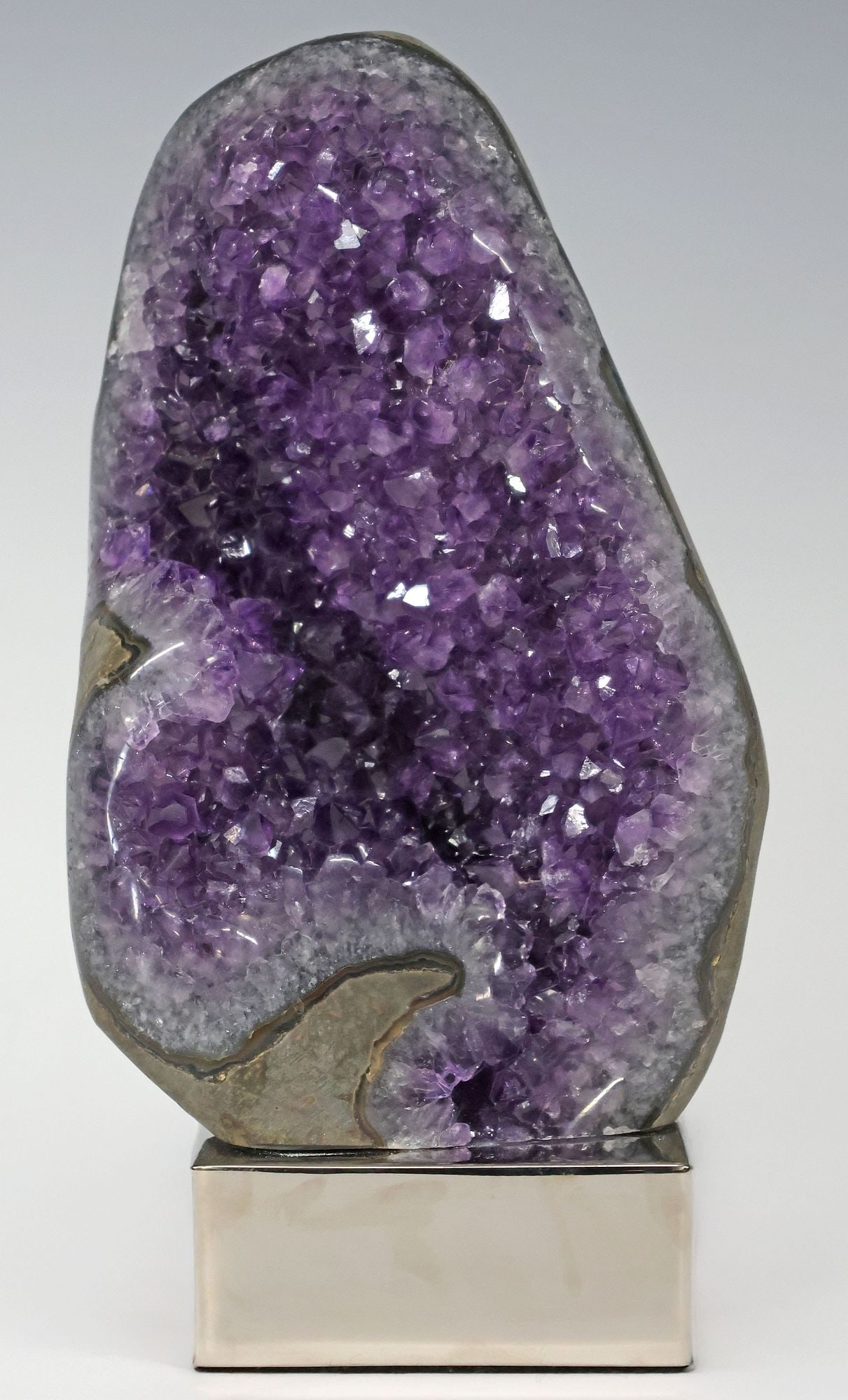 GEOLOGICAL AMETHYST SPECIMEN ON POLISHED NICKEL BASE: Geological amethyst geode specimen, rising on polished nickel base, specimen: approx 6.75"h, 4.5"w, 3.25"d, overall: approx 8.25"h, 4.5"w, 3.25"d, 7.5lbs