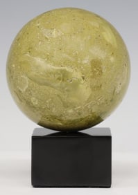GEOLOGICAL GREEN MARBLE SPHERE ON BLACK MARBLE BASE
