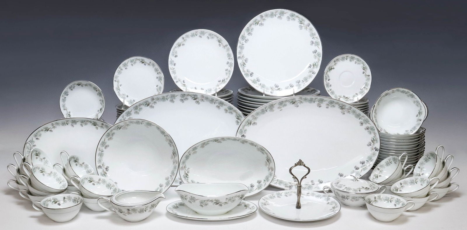 (137) JAPANESE NORITAKE 'PINETTA' PORCELAIN DINNER SERVICE: (lot of 137) Japanese porcelain dinner service, Noritake, in the "Pinetta" pattern, having silver tone trim with green and silver pine branch motifs, makers mark underfoot, including: (17) dinner