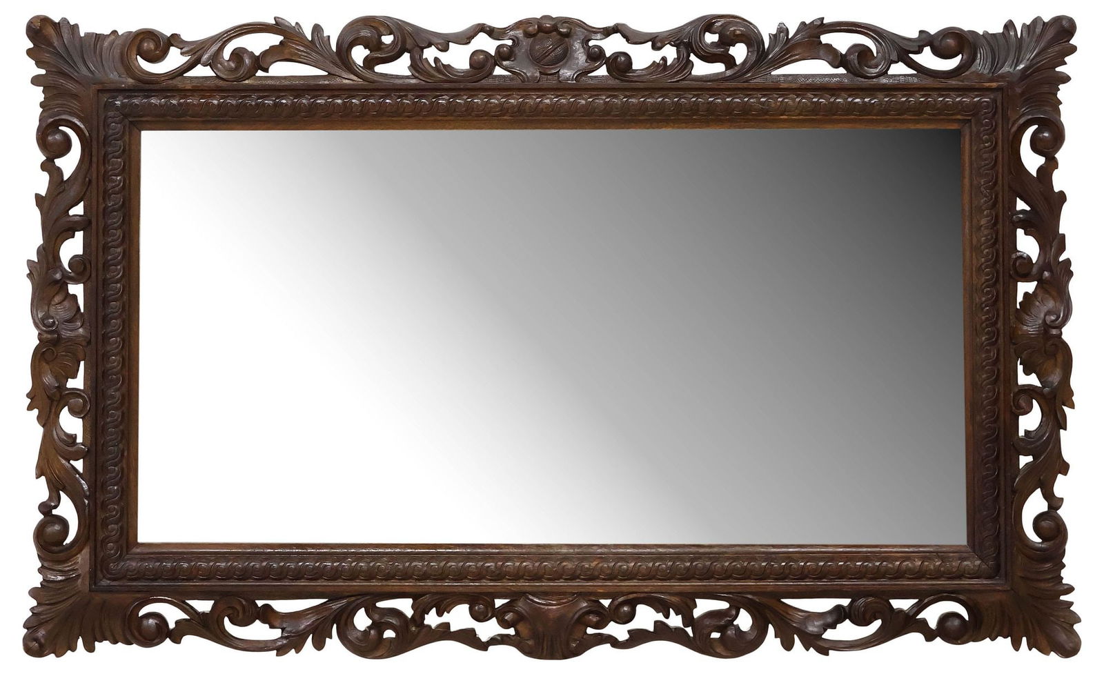 ITALIAN BAROQUE STYLE FOLIATE-CARVED WALNUT MIRROR: Italian Baroque style walnut mirror, early 20th c., having central crest, pierced frame with foliate carvings, encasing flat mirror plate, approx 21.5"h, 36"w, 15.25lbs