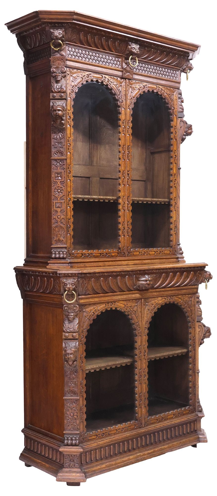 LARGE ENGLISH VICTORIAN CARVED OAK 'GREEN MAN' BOOKCASE: English Victorian carved oak bookcase, 19th c., having molded cornice, above dual arched and glazed doors, lower case fitted with gadrooned drawer centering "Green Man" mask, flanked by beast masks wi