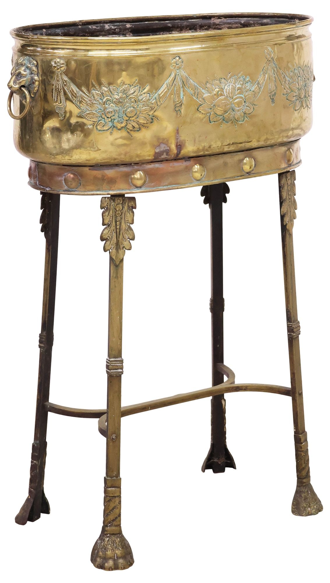 ENGLISH EDWARDIAN BRASS FLORAL REPOUSSE JARDINIERE / PLANTER ON STAND: English Edwardian brass planter/jardiniere on stand, early 20th c., having ovular body with repousse floral drapery swag, dual lion mask ring handles, supported on a gilt metal stand, on paw feet, pla