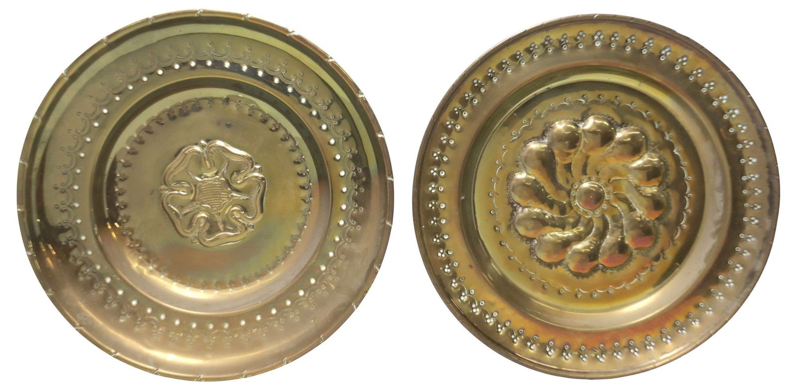 (2) CONTINENTAL FLORAL REPOUSSE BRASS ALMS DISHES: (lot of 2) Continental brass alms dishes, early 20th c., with repousse and embossed decoration, including: (1) gadrooned central motif, (1) five-petaled flower, largest: approx 18 1/8"diam, 5lbs total