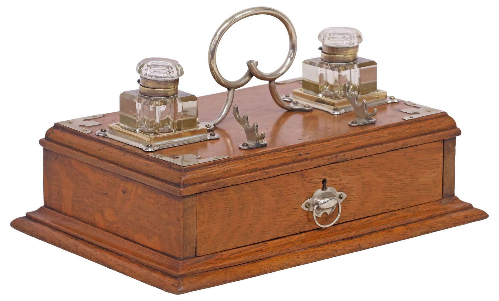 ENGLISH OAK DESK STAND WITH DRAWER & TWO INKWELLS: English oak inkstand with metal mounts, early 20th c., rectangular case fitted with single drawer, over stepped base, retaining two glass inkwells with faceted hinged covers, centering raised scrolled