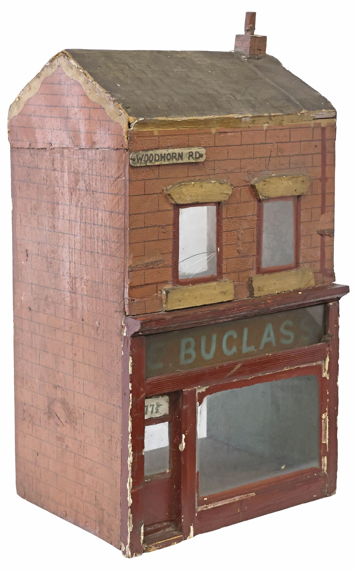 ENGLISH 2-STORY WOOD & GLASS STOREFRONT DOLL HOUSE: Rustic English wood and glass doll house, late 19th c./ early 20th c., gable roof, over rectangular frame, with hand-painted shingles and brick, Woodhorn Rd street sign, glass paneled windows and stor