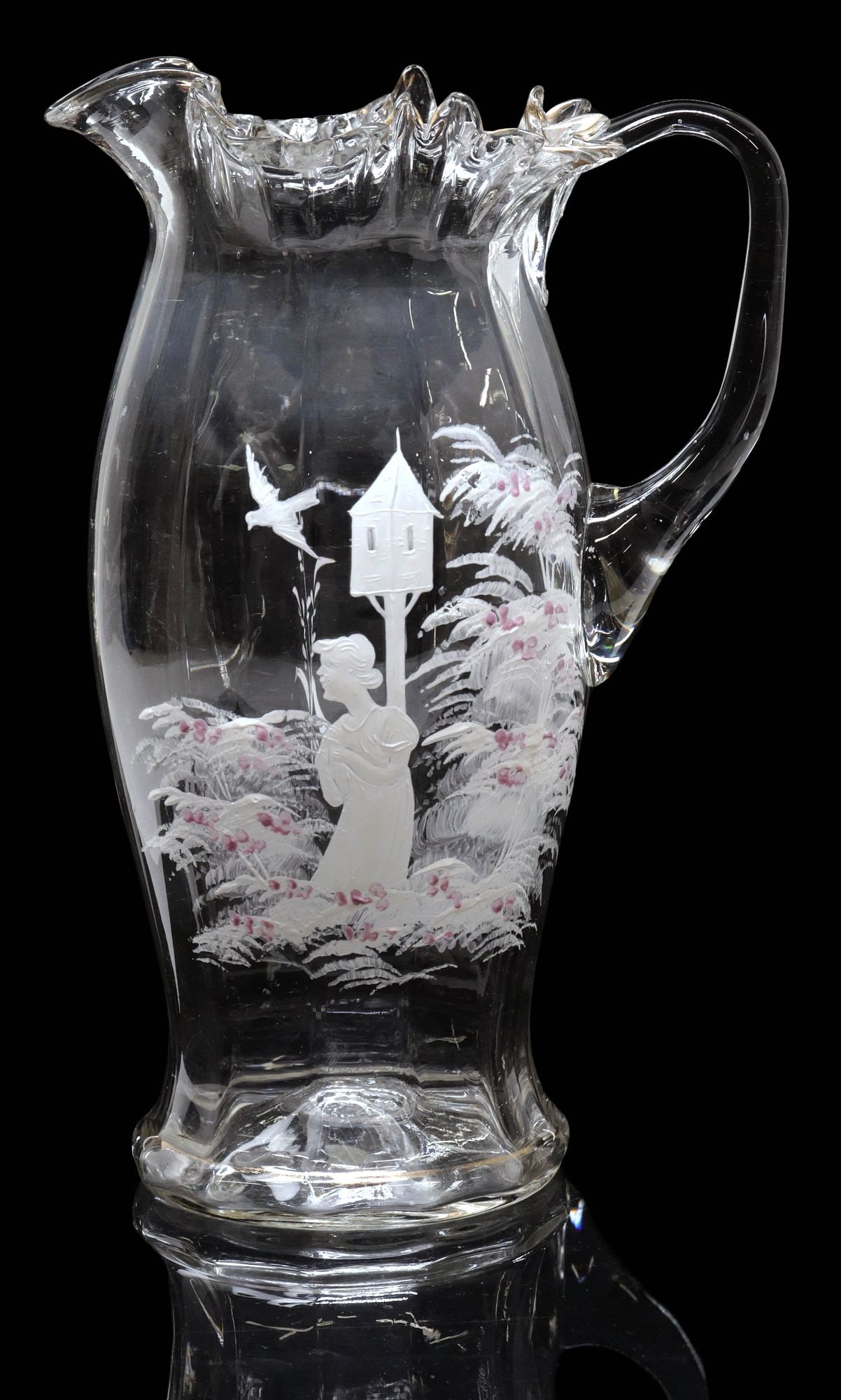 MARY GREGORY STYLE ENAMELED BLOWN ART GLASS PITCHER: Mary Gregory style blown art glass pitcher, late 19th/ early 20th c., having flared and ruffled rim, above colorless paneled body, with white and pink enamel decoration, depicting a young lady and a b