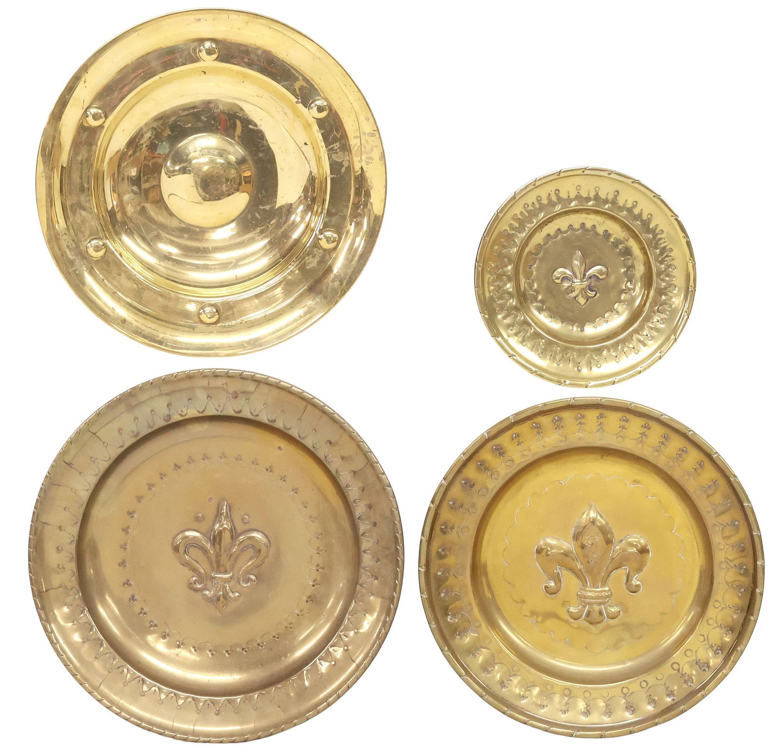 (4) CONTINENTAL REPOUSSE BRASS ALMS DISHES, 3 FLEUR-DE-LIS: (lot of 4) Continental brass alms dishes, late 19th/ early 20th c., with repousse and embossed decoration, including: (3) central fleur-de-lis, (1) shallow dome, largest: approx 12"diam; 4lbs total