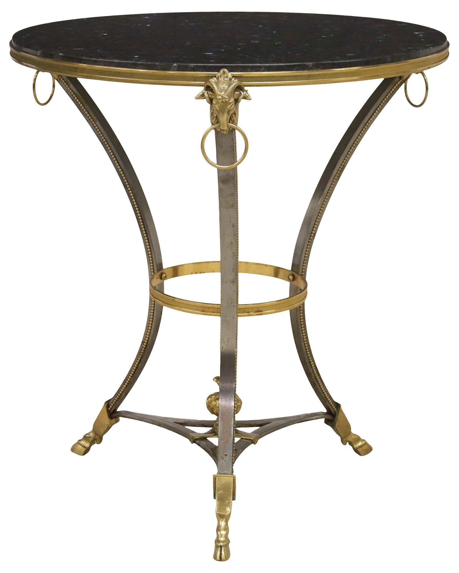 NEOCLASSICAL STYLE GRANITE-TOP GILT-METAL GUERIDON / SIDE TABLE: Neoclassical style gilt-metal side table/ gueridon, 20th c., having inset black granite top, ram's head terminals with captured rings, rising on curved supports, ending on hoof feet, medial shelf lack