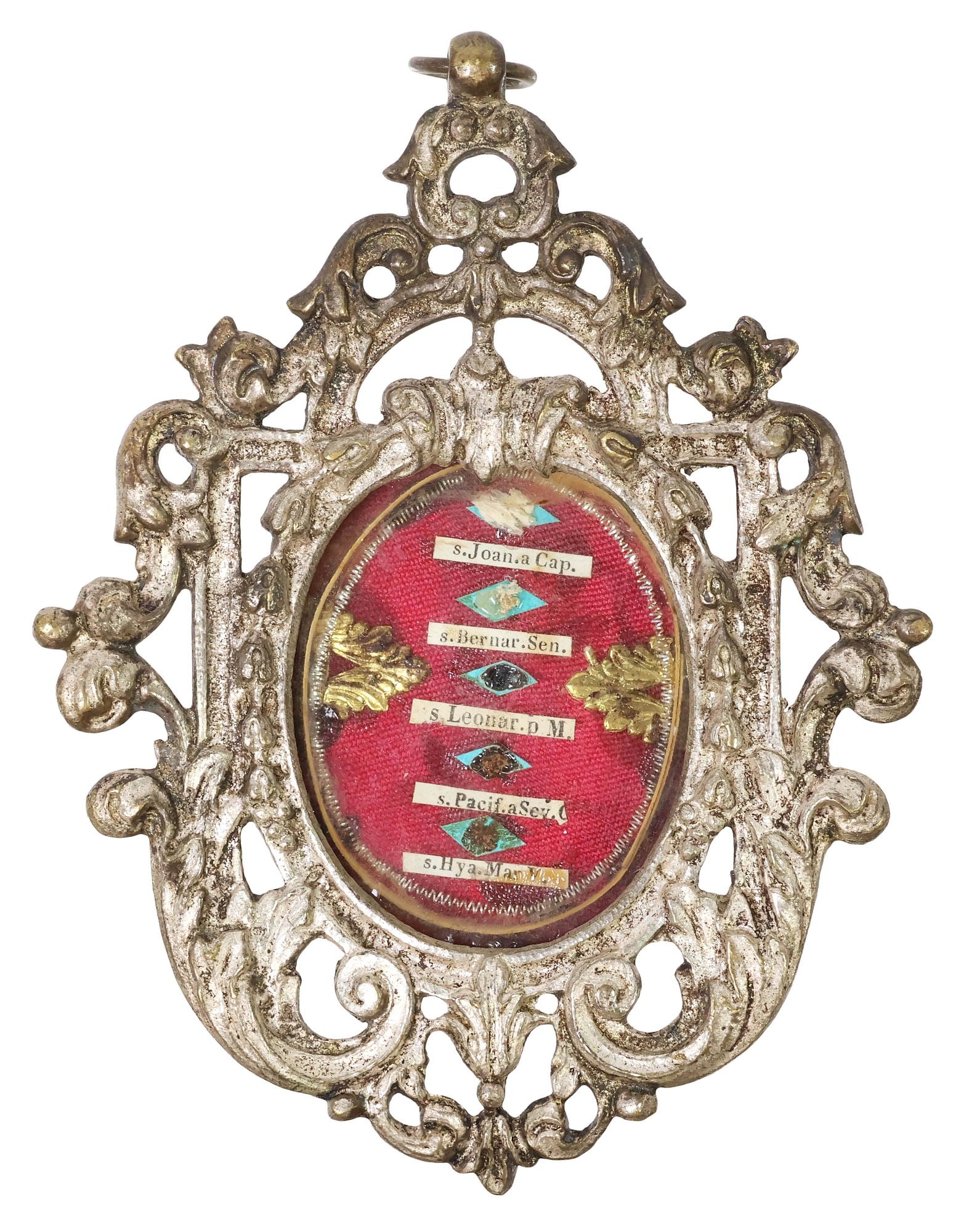 ANTIQUE CAST METAL RELIQUARY CONTAINING RELICS OF 5 FRANCISCAN SAINTS: Religious silver-tone cast metal reliquary, late 18th/ early 19th c, housing (five) relics of Franciscan saints, all of the Order of the Friars Minor, comprising Saints John of Capistrano, Bernardine