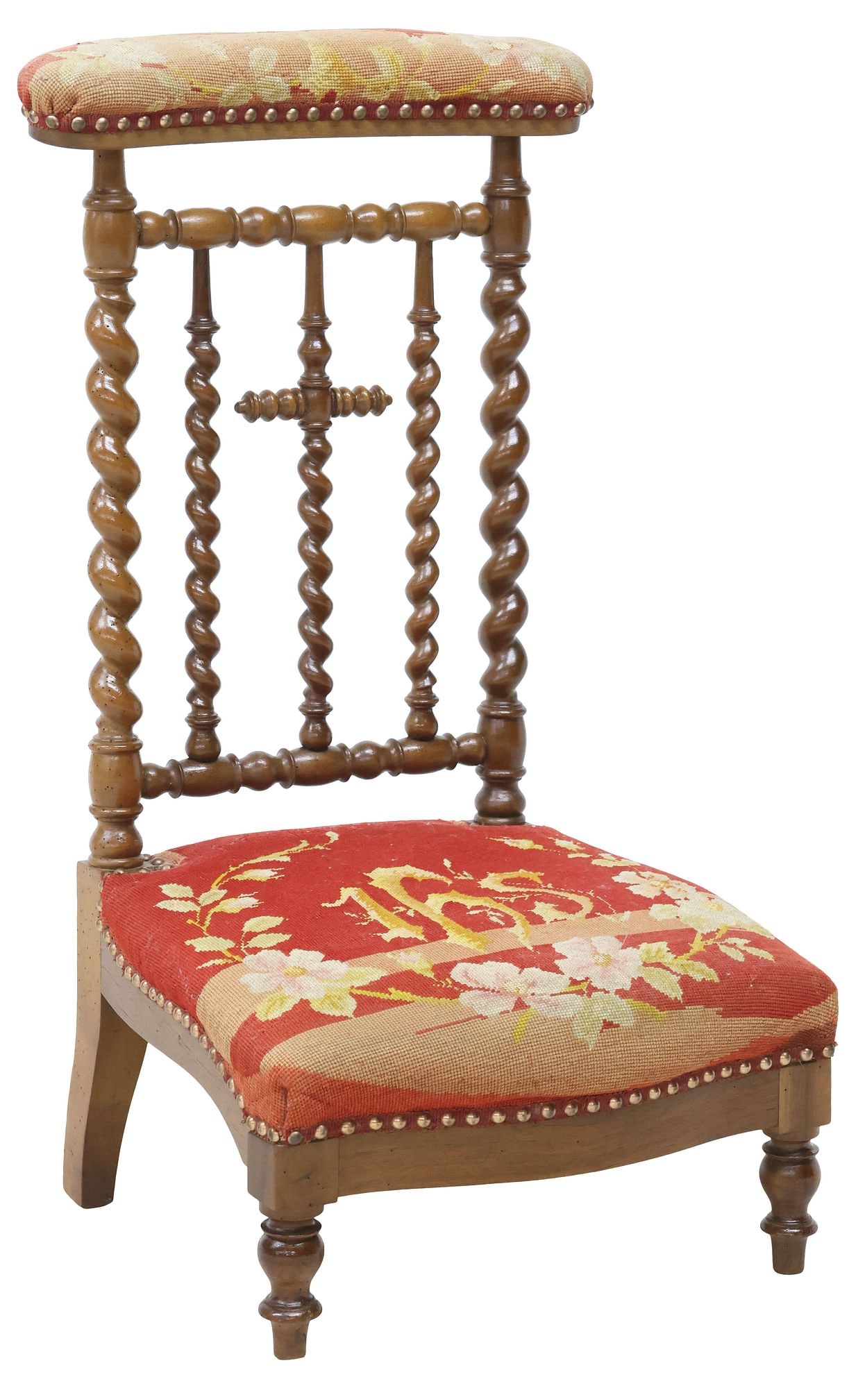 FRENCH NEEDLEPOINT-UPHOLSTERED PRIE DIEU / PRAYER KNEELER: French carved wood prie-dieu/ prayer kneeler, late 19th c., having padded top rail and seat in needlepoint upholstery, the seat with Christogram in floral wreath, spiral-turned back with cross-form sp