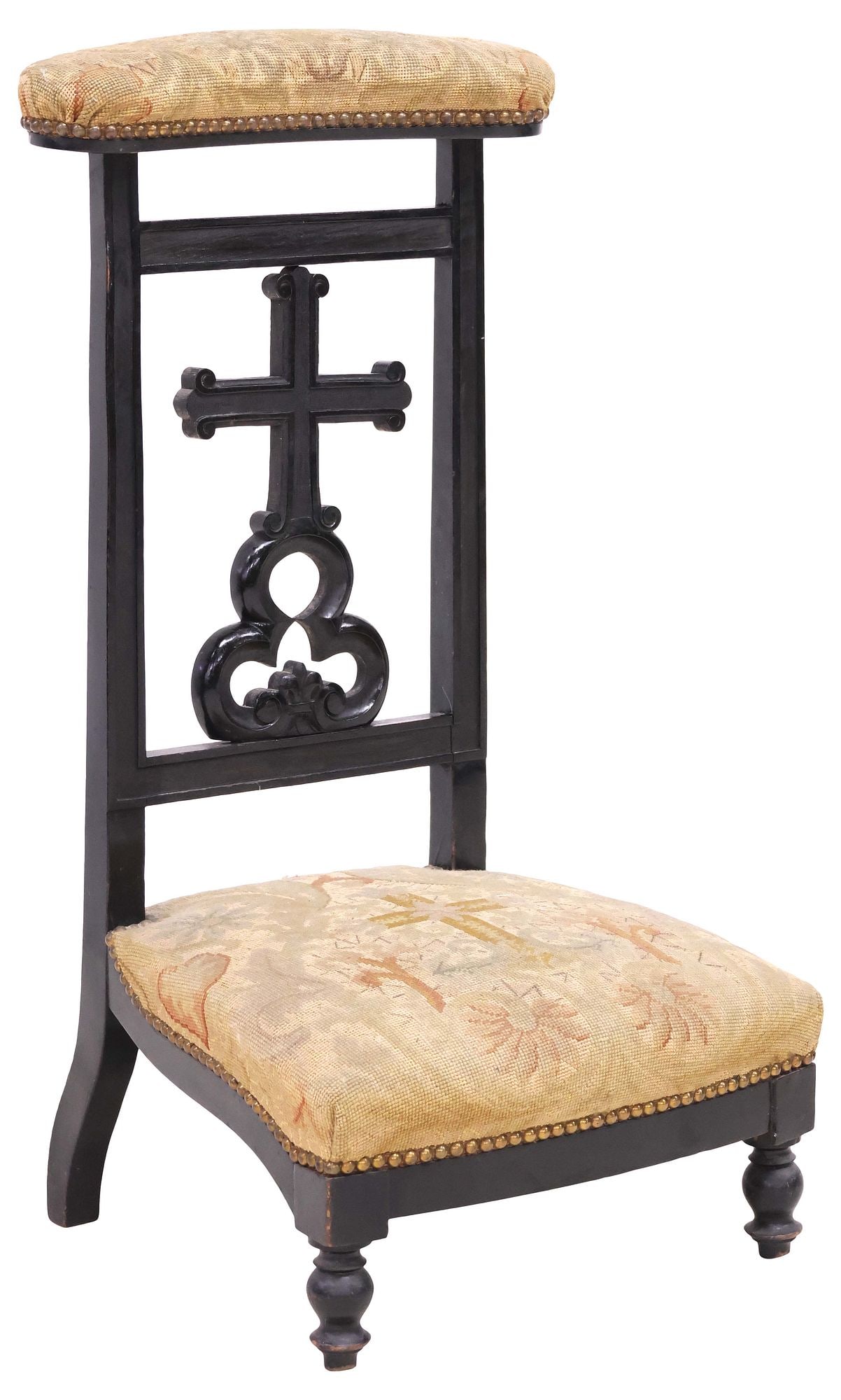 FRENCH EBONIZED & NEEDLEPOINT UPHOLSTERED PRIE DIEU / PRAYER KNEELER: French ebonized prie-dieu/ prayer kneeler, late 19th c., padded top rail and seat in a floral-patterned needlepoint upholstery, with nailhead trim, carved crucifix splat over trefoil motif, on turned