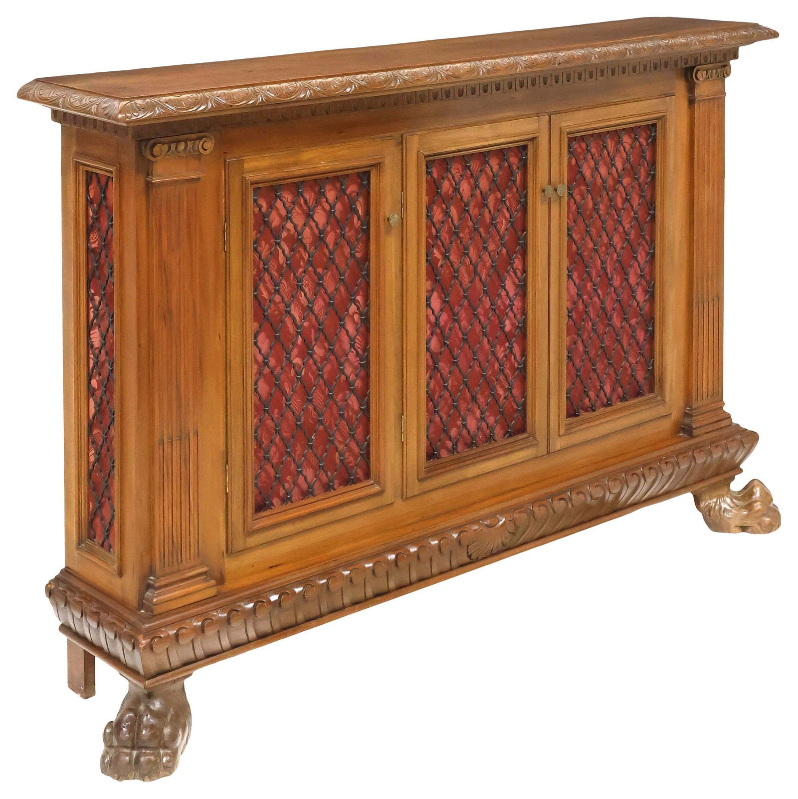 ITALIAN RENAISSANCE REVIVAL CARVED WALNUT & WROUGHT IRON BOOKCASE: Italian Renaissance Revival walnut bookcase, early 20th c., narrow top trimmed with floral lunettes, above three doors with wrought iron paneling and damask fabric backing, enclosing fixed shelving, f