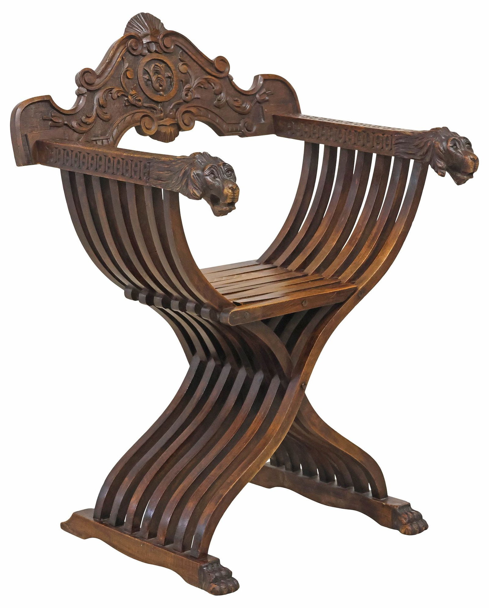 ITALIAN RENAISSANCE REVIVAL CARVED WALNUT SAVONAROLA CURULE CHAIR: Italian Renaissance Revival carved walnut Savonarola chair, early 20th c., having fanned scrolling crest, over folding slatted frame, lion mask hand holds, rising on shoe base with paw feet, approx 37