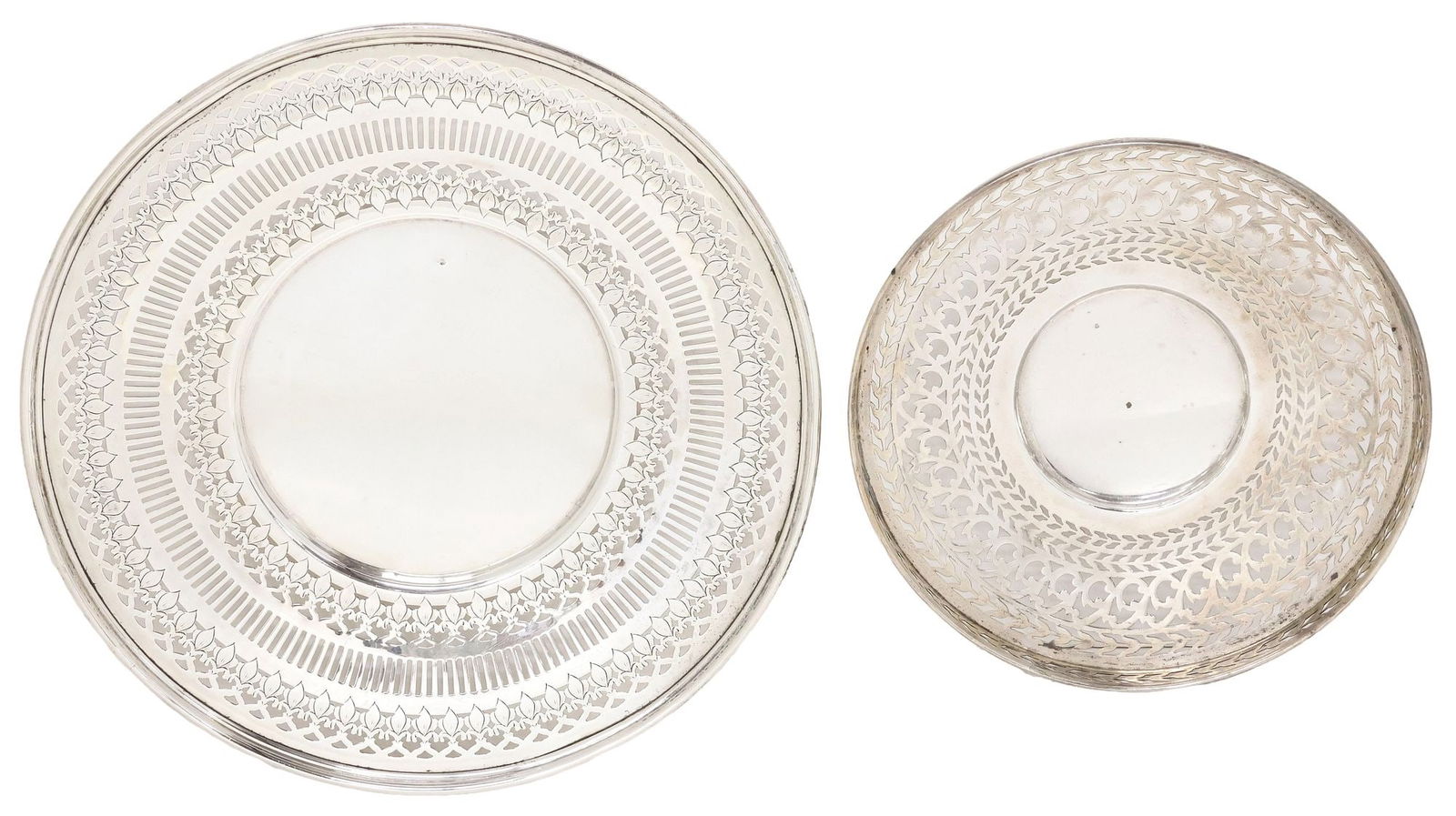 (2) AMERICAN RETICULATED STERLING SILVER SERVICE PLATES/DISHES: (lot of 2) American sterling silver reticulated service dishes, including: (1) Matthews Company, retailed by J.E. Caldwell and Company, wide foliated and pierced rim, simple well with dent, misshapen