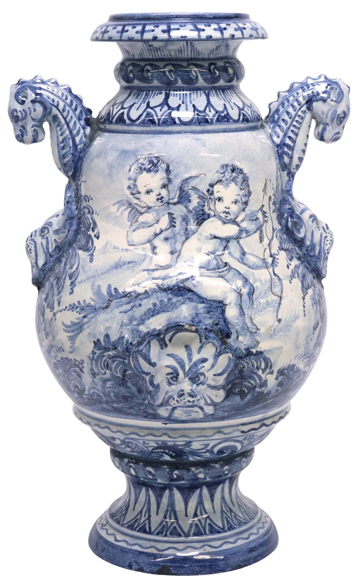 LARGE ITALIAN ALBISOLA BLUE & WHITE MAJOLICA HANDLED VASE: Italian majolica earthenware vase, Albisola, 20th c., handles formed as serpents over masks, baluster-form body painted with a castle in landscape to one side, reversed by winged cupid and putto, grot