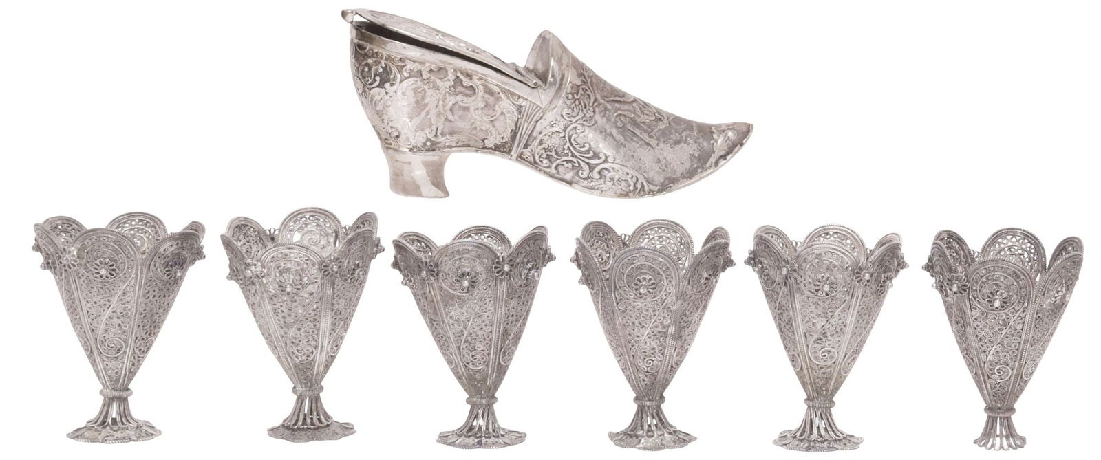 (7) ISLAMIC SILVER FILIGREE ZARF CUP HOLDERS & CONTINENTAL SHOE-FORM BOX: (lot of 7) Silver (content unknown) holders and shoe-form vanity box, including: (6) Ottoman style filigree zarfs or coffee cup holders, likely Turkish, each having tapering body with scalloped trim,