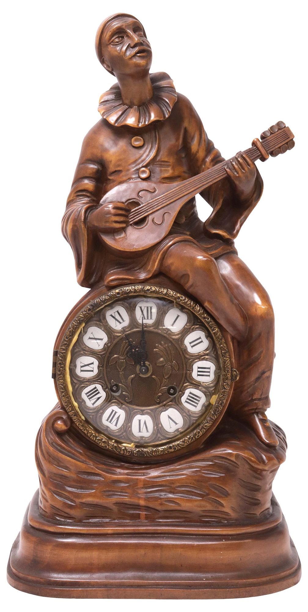 ITALIAN FIGURAL CARVED WOOD MUSICAL PIERROT MANTEL CLOCK: Italian carved wood figural mantel clock, early 20th c., surmounted by a seated Pierrot playing the guitar, cast gilt-metal dial with inset porcelain hour markers, time-and-strike movement, with doubl