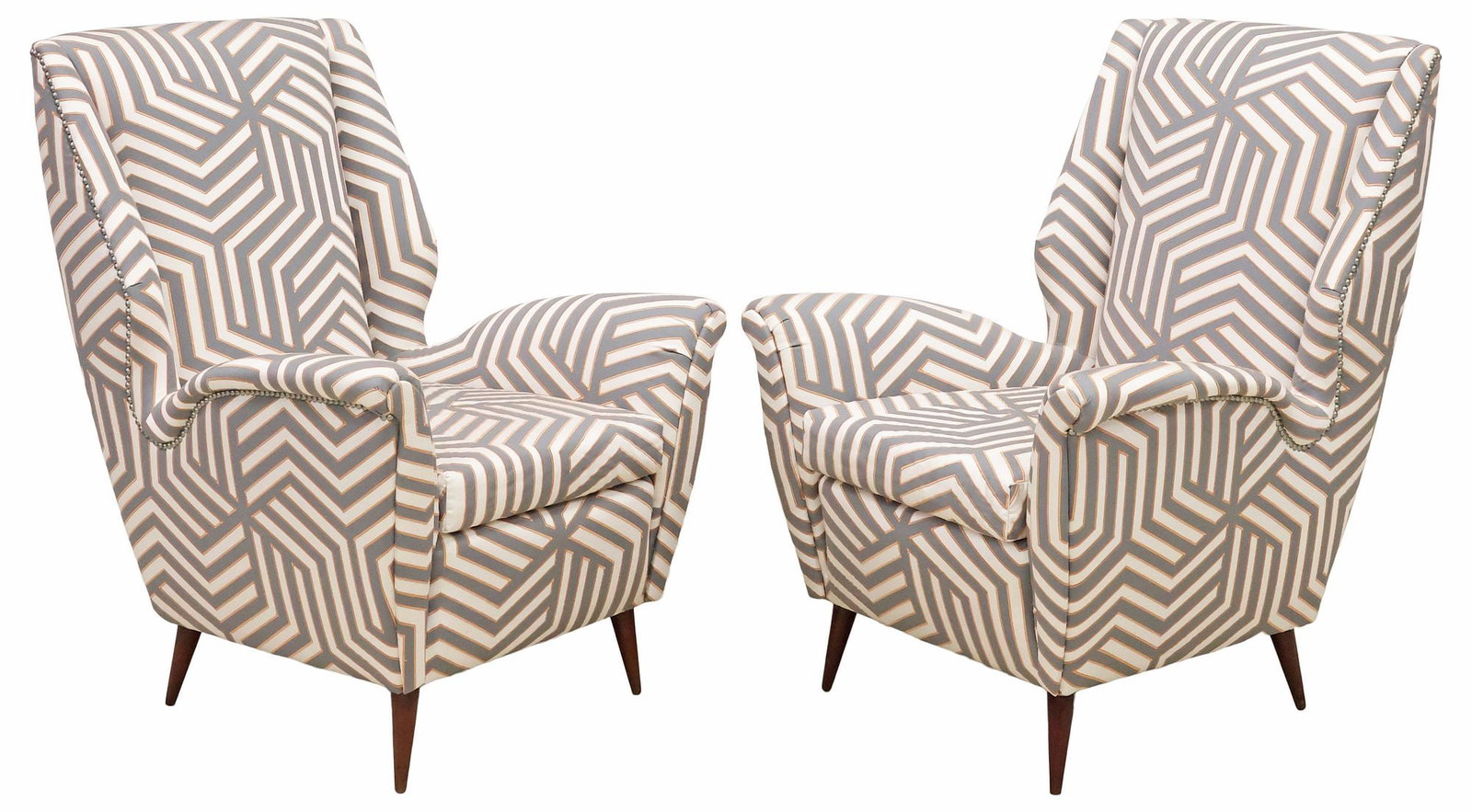 (2) ITALIAN GIO PONTI STYLE MID-CENTURY MODERN UPHOLSTERED WINGBACK ARMCHAIRS: (pair) Italian mid-century modern wingback armchairs, in the manner of Gio Ponti (Italian, 1891-1979), c.1950s, each in a later geometric upholstery with metallic embroidery, and nail-head trim,