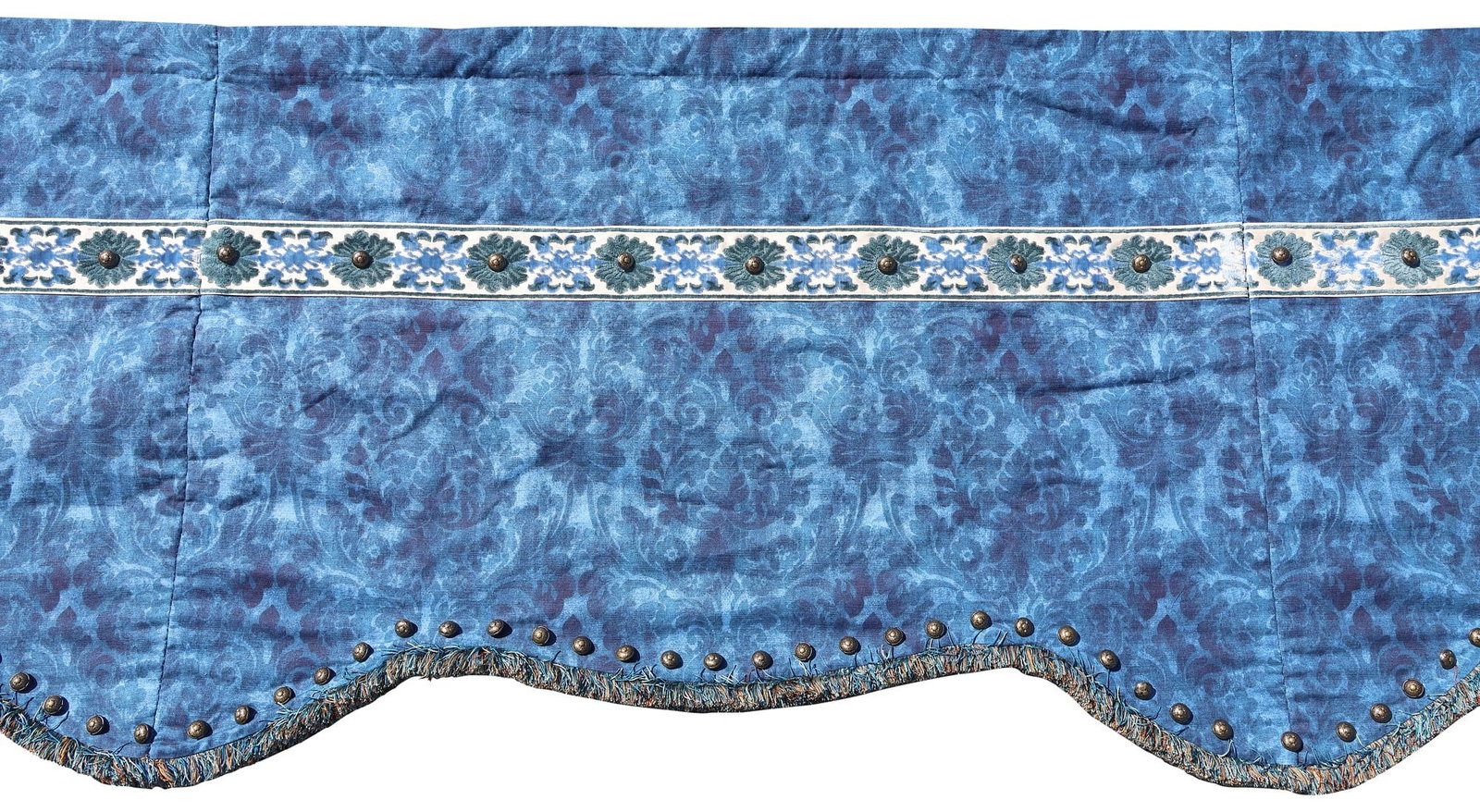 CUSTOM BLUE DAMASK WINDOW VALANCE / DRAPERY PANEL, 155"L: Custom window valance, in a blue damask upholstery, with scalloped fringed trim, and patinated metal button accents, approx 155"l, 37"w, 8.5lbs **Provenance: Dallas, Texas: When the madness of collect