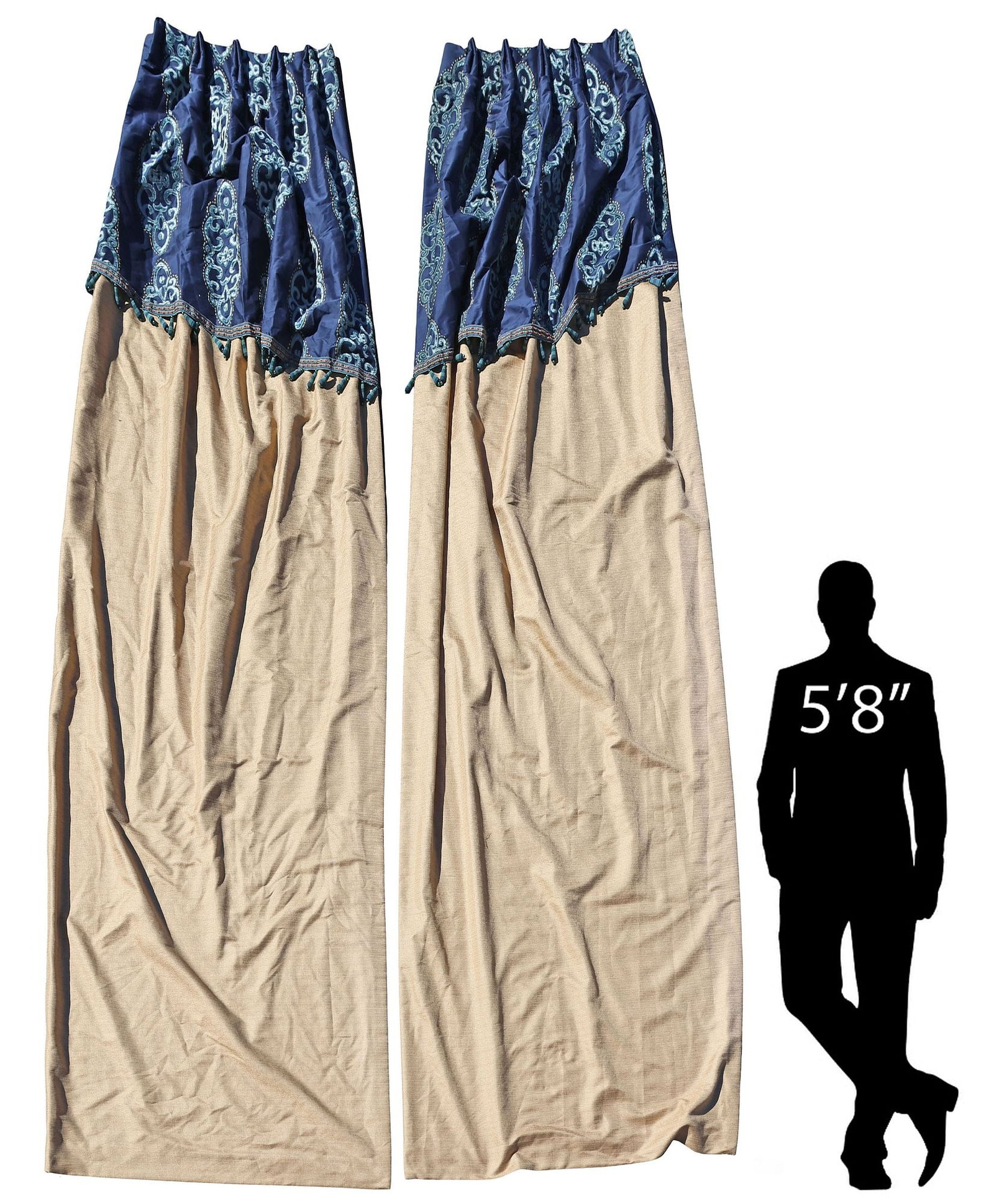 (2) CUSTOM-MADE CURTAINS WITH TASSELED VALANCES, 130"L X 24"W: (pair) Custom-made curtains, in a pale gold fabric, with attached slanted blue valance, and tasseled trim, having sewn-in pleats and silver-toned hooks at top, lined with two panels of white fabric, b